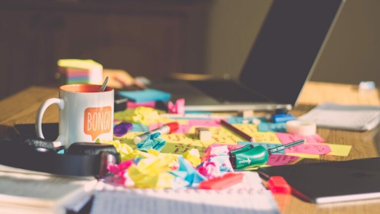 A Desk With a Laptop and a Cup of Coffee and Sticky Notes